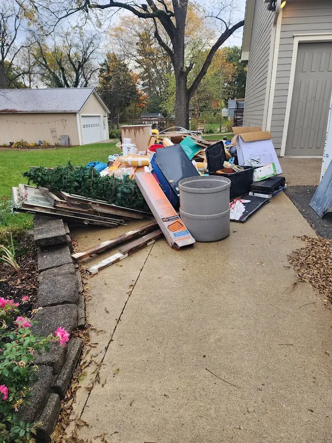 Dumpster being loaded with debris for 10 Yard Dumpster Rental in Jamestown